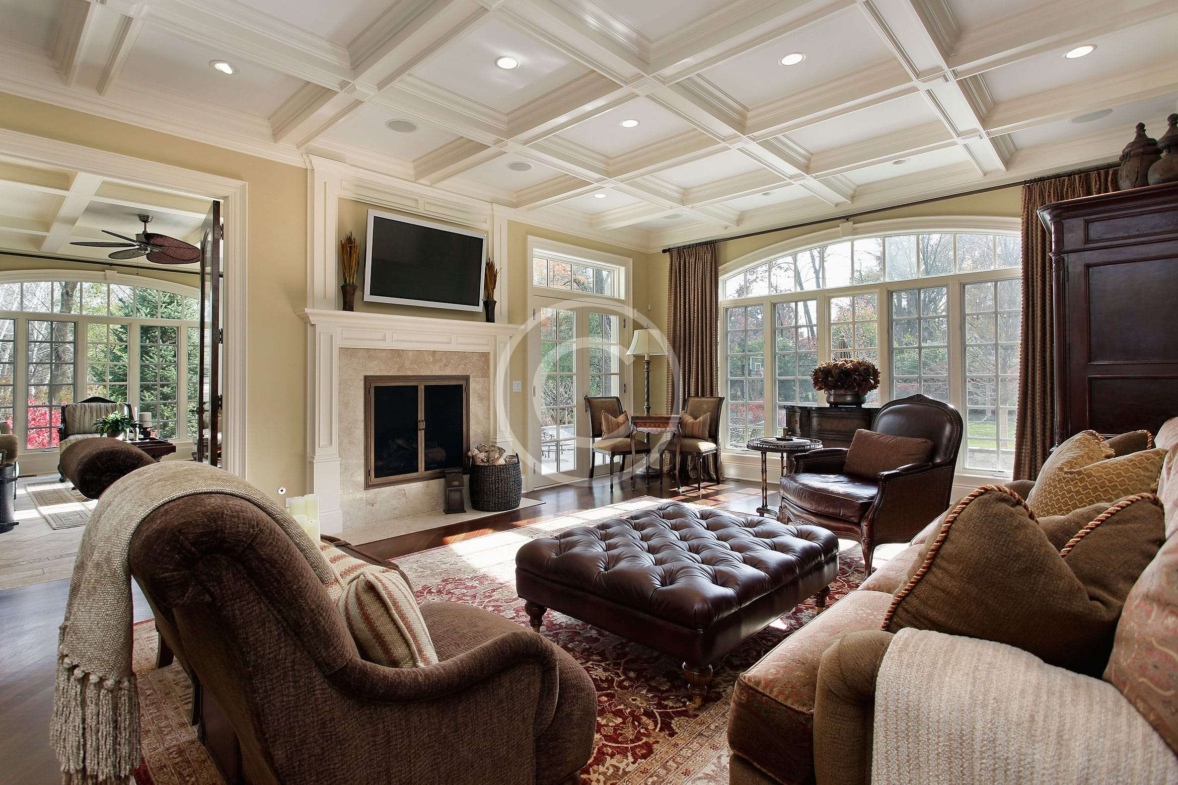 A living room with a fireplace and a large window.