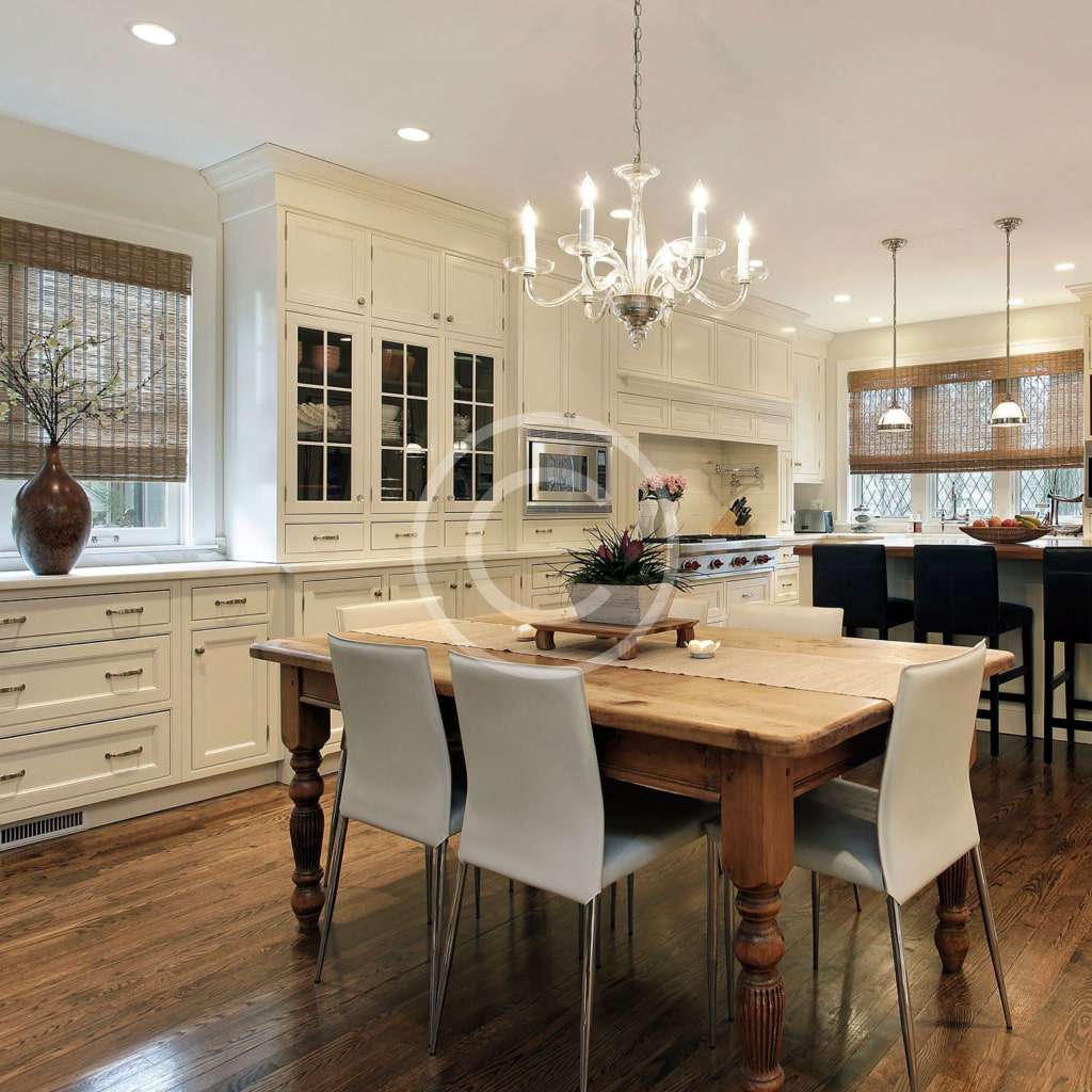 A dining room with white walls and wooden floors