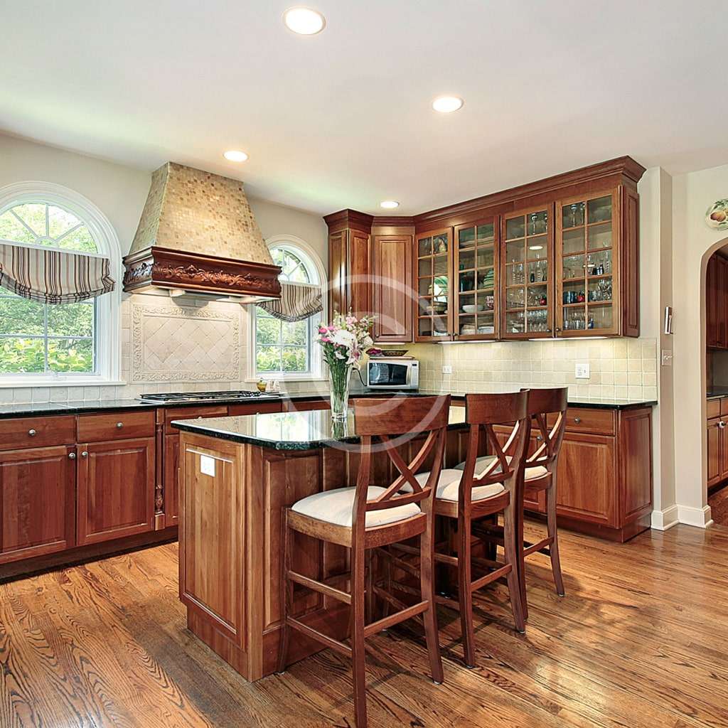 A kitchen with wooden floors and cabinets