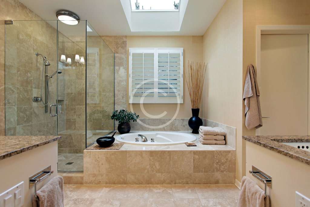 A bathroom with a large tub and shower.