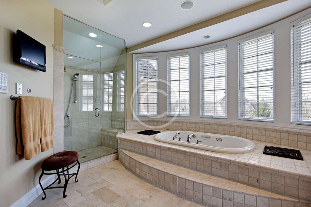 A large bathroom with a tub and shower.