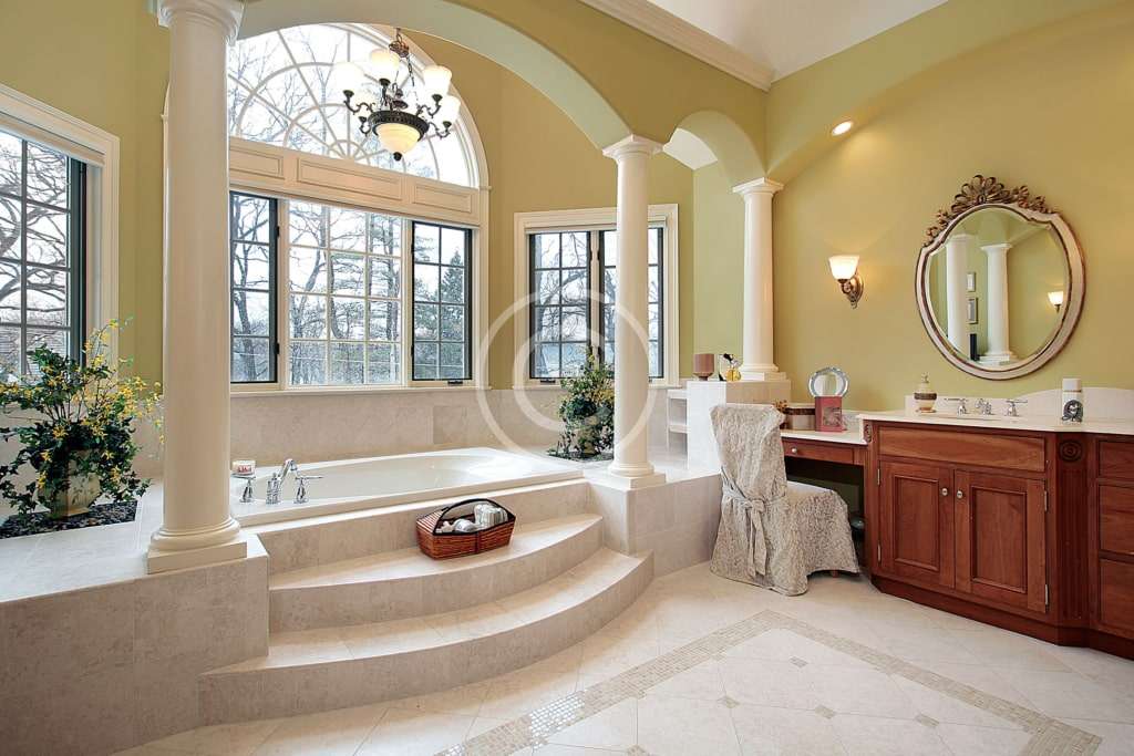 A bathroom with a large tub and sink.