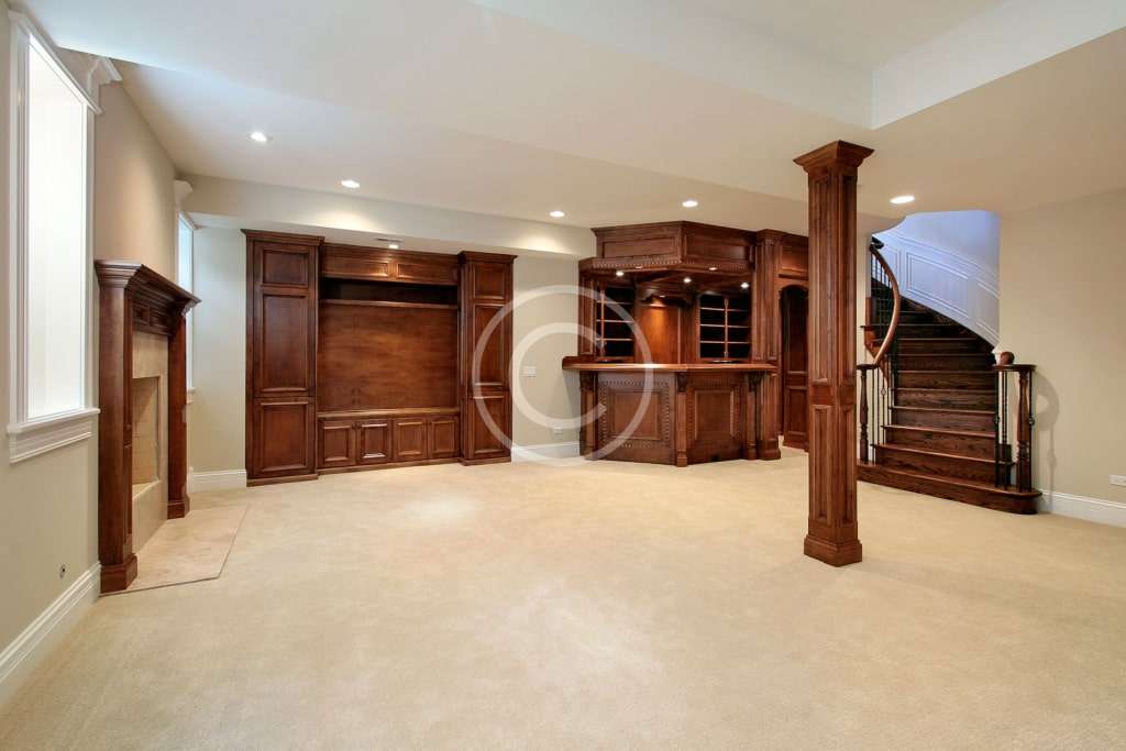 A large room with wooden cabinets and pillars.