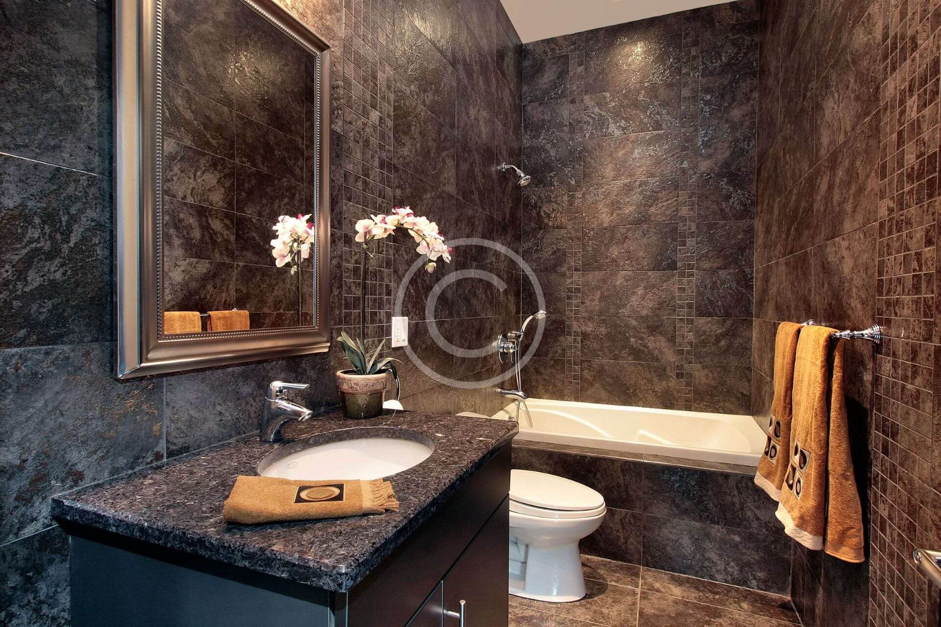 A bathroom with marble walls and floors